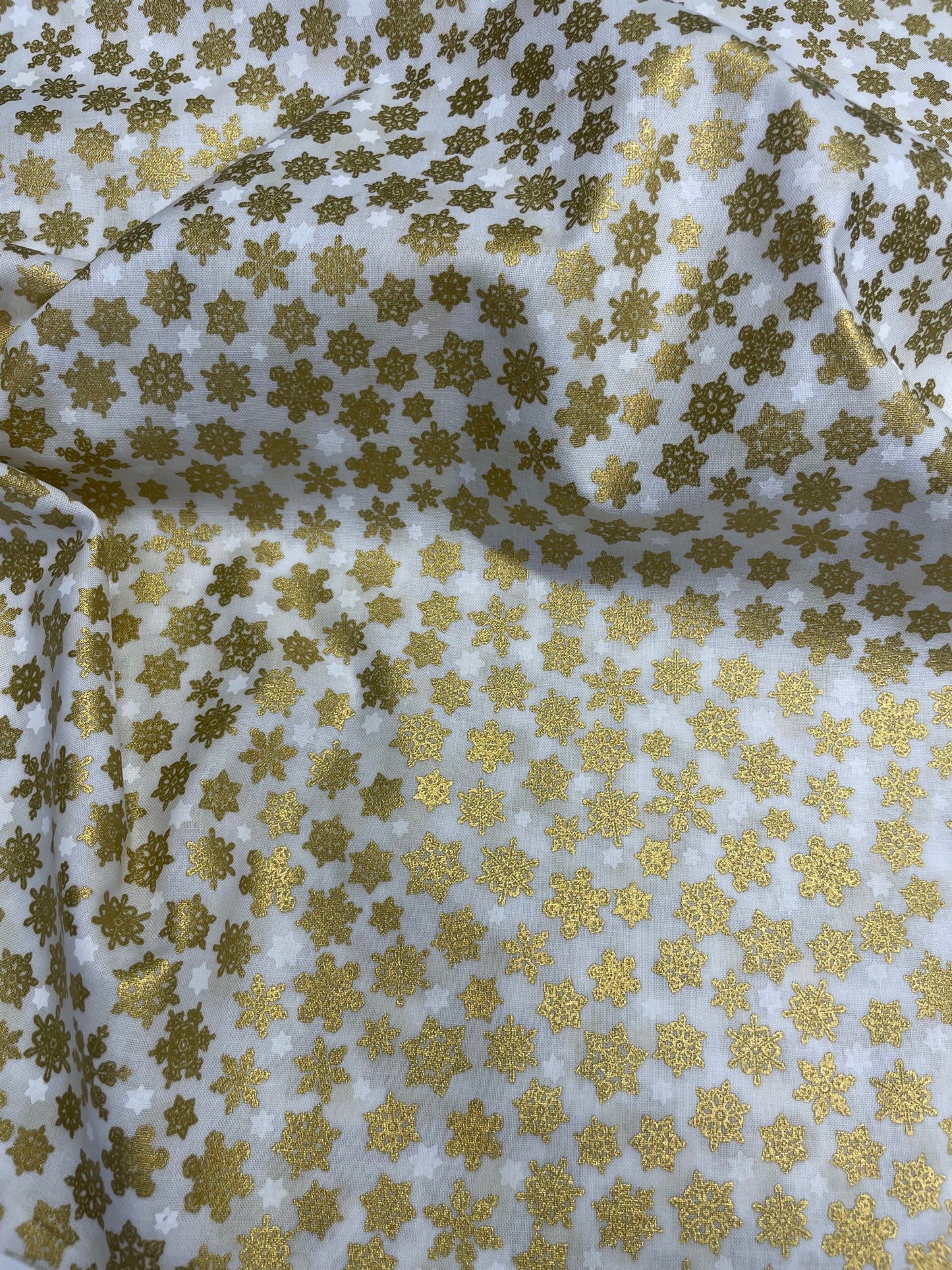 white cotton with gold snowflakes
